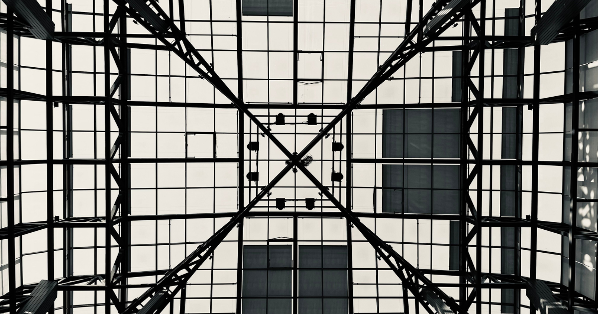 Black and white geometric steel and glass ceiling grid photographed from directly below
