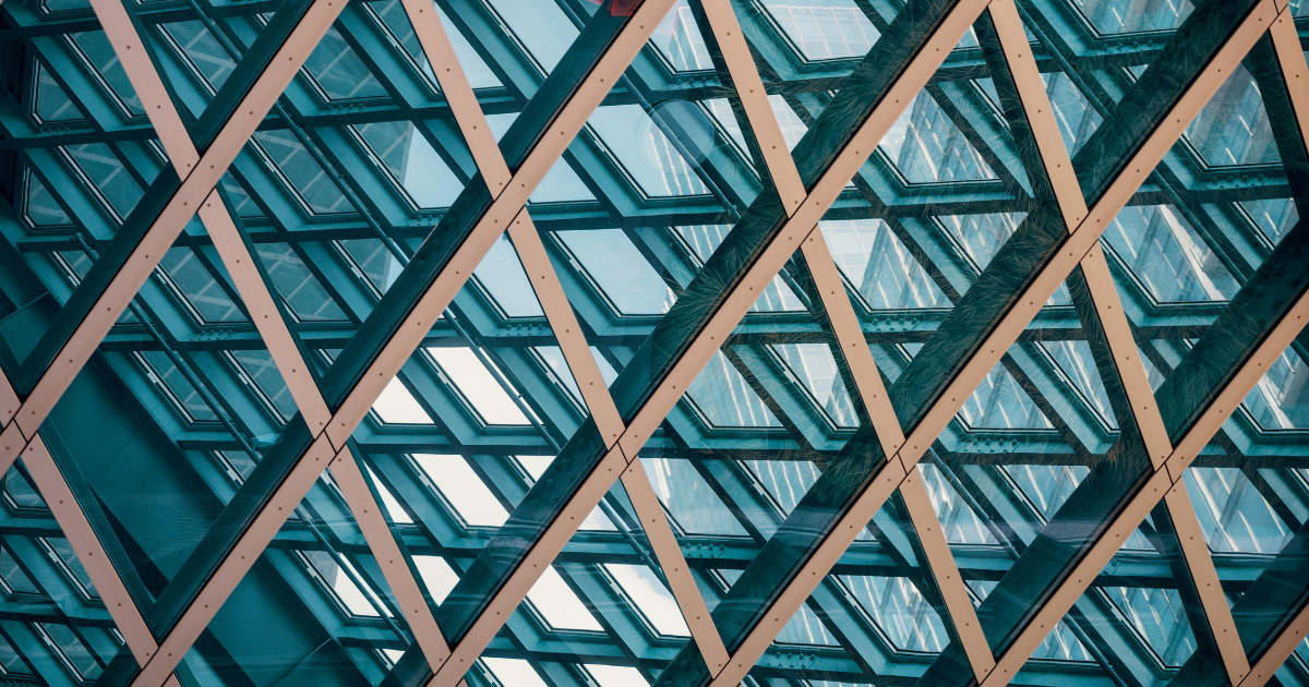 Geometric steel and glass architectural ceiling grid photographed from directly below